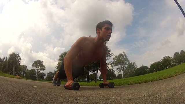 male in sportswear doing push ups. Outdoors workout