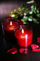 Beautiful romantic red candles with flower petals