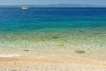 Beautiful beach with ship and island Hvar in background