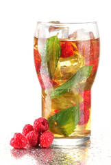 Iced tea with raspberries and mint isolated on white
