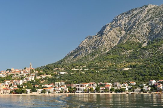Village of Igrane with tower, adriatic sea and mountain Biokovo