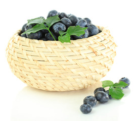 Blueberries in wooden basket isolated on white