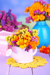 Bouquet of marigold flowers in watering can