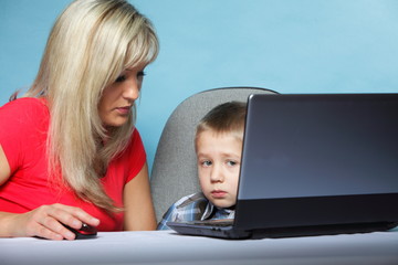 mother with son looking on the laptop