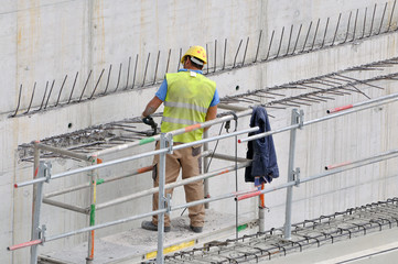 Worker on the construction of a high tower