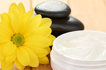 Fototapeta na wymiar cosmetic cream with herbal flower