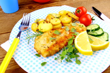 Fried fish fillet with rosemary potatoes and vegetables