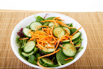 Vegetable Salad in White Bowl on Bamboo mat