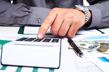 Hand with calculator and money.