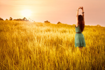 Happy young asian woman standing in meadows