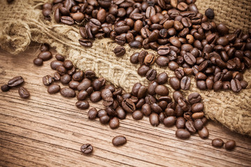 Fresh coffee beans on wood background
