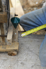 labor man using a plumb bob for check .