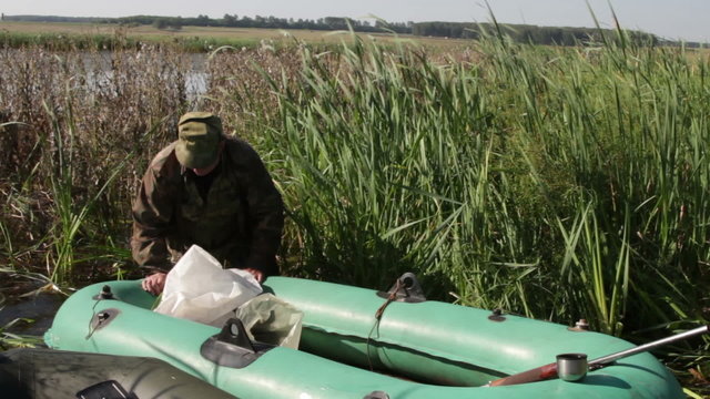 Hunter pulls out a dinghy on the shore