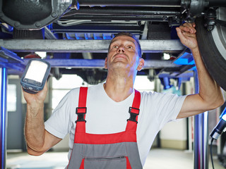 Motor mechanic inspecting the engine of a car