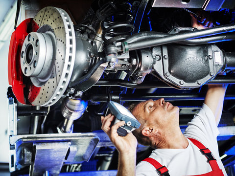 Motor mechanic inspecting the engine of a car