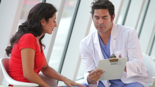 Doctor Discussing Notes With Female Patient