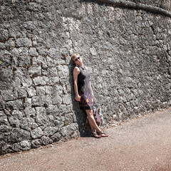 woman against old stone wall