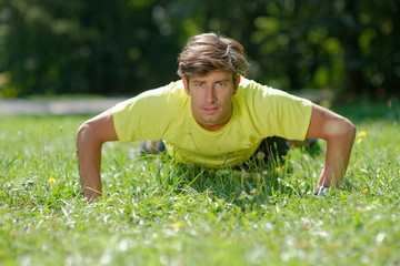Athlete doing Push ups in the park