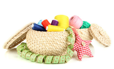 Wicker basket with accessories for needlework isolated on white