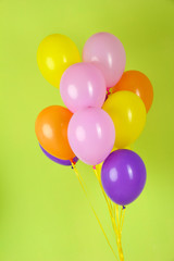 Colorful balloons on green background