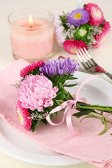 Obraz na płótnie Canvas Festive dining table setting with flowers