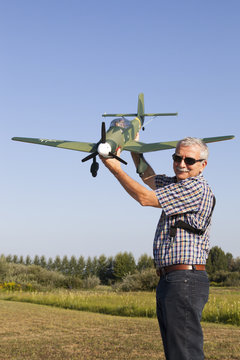 Friendly senior RC modeller showing his new plane model