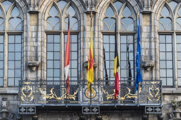 Flags on City Hall facade in Mons, Belgium.