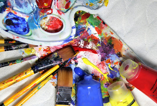 Art palette, tubes with paints and paintbrushes