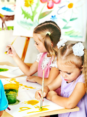 Child painting at easel.