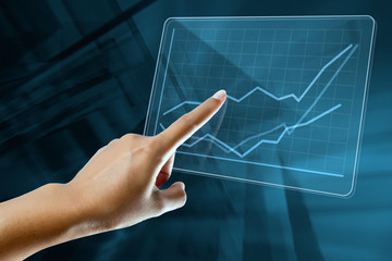 a woman finger make a graph on a digital screen