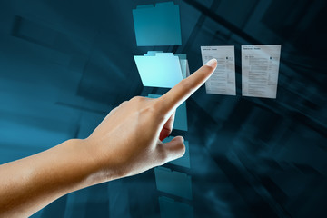 a woman hand select and open a folder on a digital screen