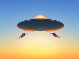 a flying saucer followed by two fighter jets