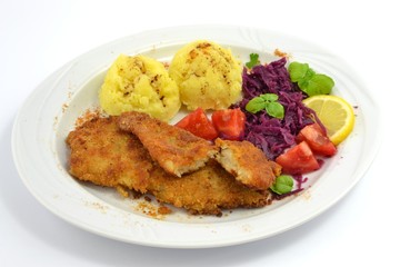 pollock fried with potatoes and vegetables