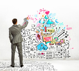 Businessman drawing sketches on wall