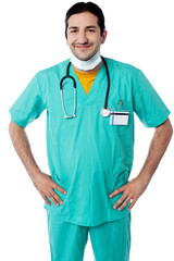 Young male physician posing confidently