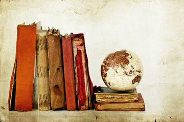 Plie of old books with globe