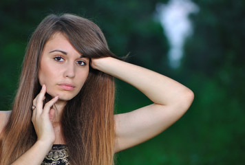 Girl in a black evening dress in the wood