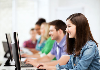 students with computers studying at school