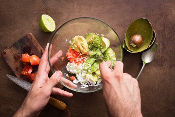 Mashing vegetables to make guacamole