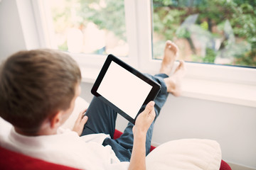 Man using tablet on sofa at home