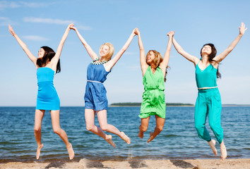 girls jumping on the beach