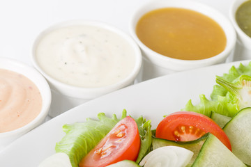 Salad & Dressings - Tomato and cucumber salad with four sauces.