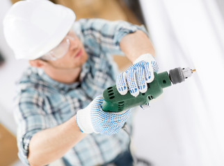 man drilling the wall
