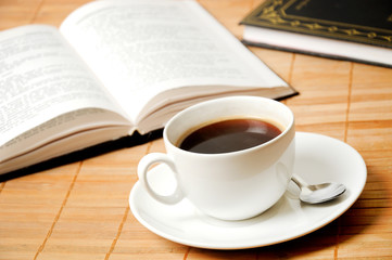 Cup of coffee with books