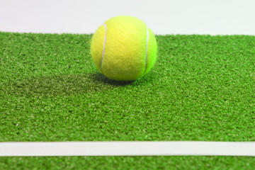 Tennis concept. Ball, line and green grass tennis court.horizo