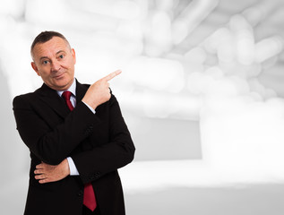 Businessman pointing his finger to the copy space