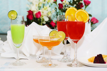 exotic cocktails and flowers on table