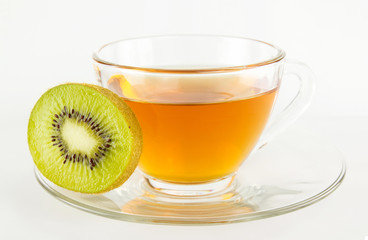tea in cup and pice of kiwi fruit