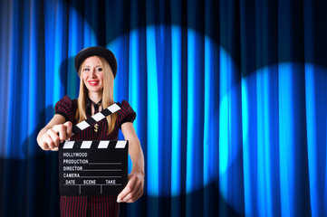 Woman gangster with movie clapper