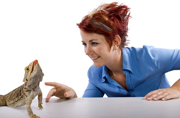 Spikey-haired girl staring at spikey bearded dragon reptile